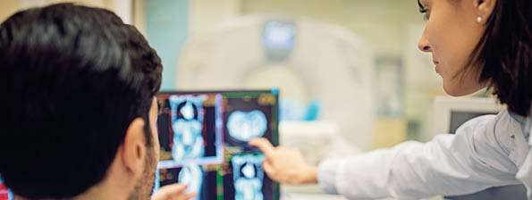 Doctors are working with CT scan in hospital