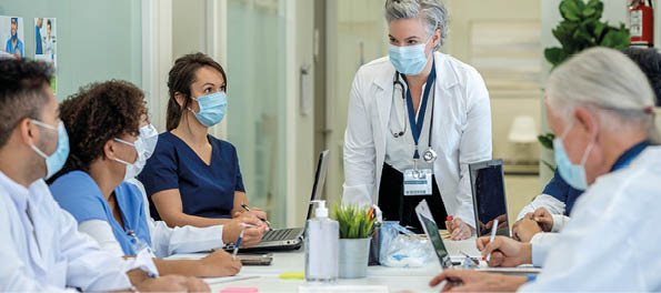 Group of medical students in a medical training class, all are wearing masks due to COVID-19 